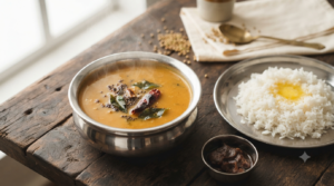 Jain Sambar Recipe Without Vegetables served in a steel bowl with steamed rice