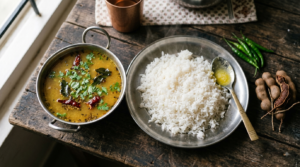 Pappu Charu Telangana Style in a steel bowl with rice, tamarind and curry-leaf tempering