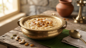 Rice payasam with jaggery in a brass bowl with roasted cashews and raisins