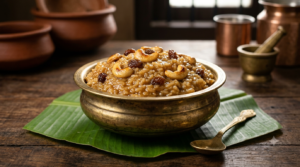 Sakkarai pongal without dal in a brass bowl topped with roasted cashews and raisins