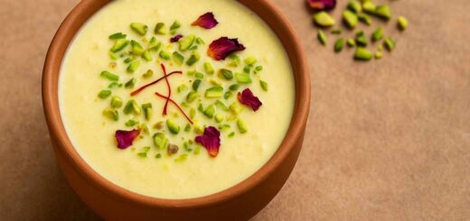 Kesar Pista Phirni served in a traditional earthen bowl garnished with saffron strands, pistachios, and rose petals