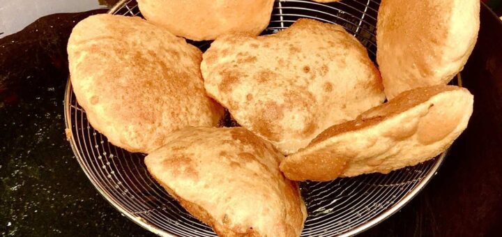 Poori Recipe Without Milk fresh golden pooris on plate